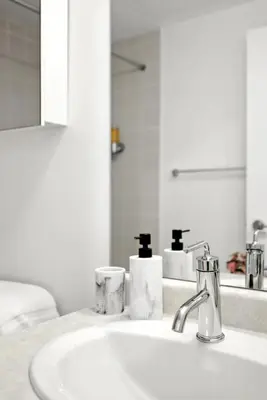 a bathroom with a sink and a mirror at Financial District Oasis Sleeps 5 55 TV in Toronto