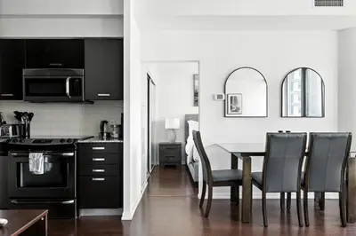 a kitchen and dining room with a table and chairs at Financial District Oasis Sleeps 5 55 TV in Toronto