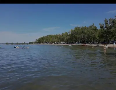 a group of people on a beach in the water at Cozy 2 bedroom ice fishing&skiing in Georgina