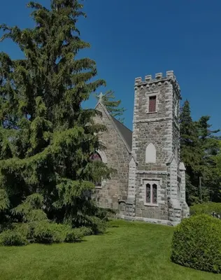 an old stone church with a tree in the foreground at Cozy 2 bedroom ice fishing&skiing in Georgina