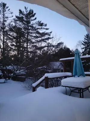 an umbrella and a table covered in snow at Cozy 2 bedroom ice fishing&skiing in Georgina
