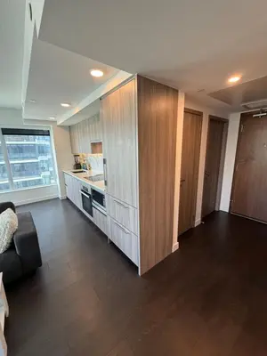 a living room with a couch and a kitchen at Luxury 2 Bedroom 2 Baths Condo Downtown Toronto in Toronto