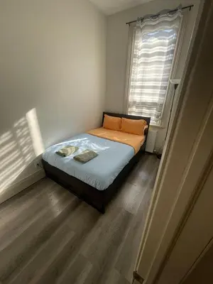a small bedroom with a bed and a window at FIFA CENTRAL TORONTO-DIRECT TO BMO FIELD-Live Game Atmosphere-Free Wifi in Toronto