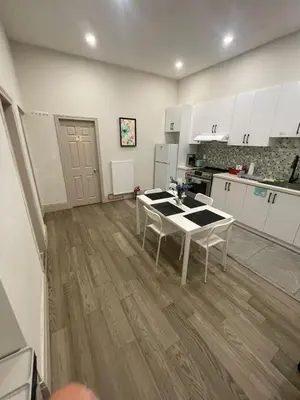 a kitchen with white cabinets and a table in it at FIFA CENTRAL TORONTO-DIRECT TO BMO FIELD-Live Game Atmosphere-Free Wifi in Toronto