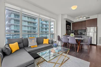 a living room with a couch and a table at Cozy 2 Bedroom Condo in Dunfield Ave Downtown Toronto in Toronto