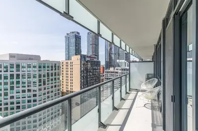 a balcony with a view of the city at Paradise Birds 1 Bedroom Condo in Downtown Toronto in Toronto