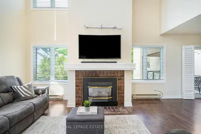 a living room with a fireplace and a flat screen tv at Mountain Home in the Heart of Blue Mountain Village in Blue Mountains