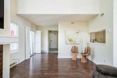 a living room with white walls and wood floors at Mountain Home in the Heart of Blue Mountain Village in Blue Mountains