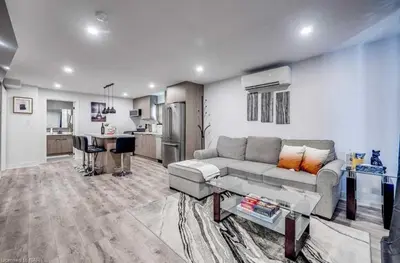 a living room with a couch and a kitchen at Niagara 3 Bed Unit Near the Falls in Niagara Falls