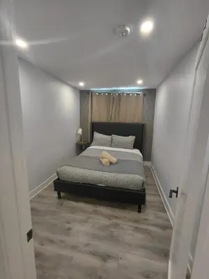 a bedroom with a bed with a pillow on it at Niagara 3 Bed Unit Near the Falls in Niagara Falls