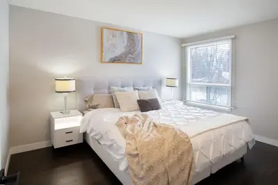 a bedroom with a white bed and a window at Spacious & Cozy in the Heart of Town in London