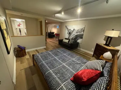 a bedroom with a bed and a living room at Spacious 4-Bedrooms Friendly House Toronto-Parking in Markham