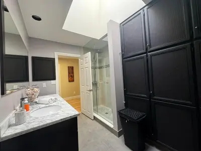 a bathroom with a sink and a glass shower at Spacious 4-Bedrooms Friendly House Toronto-Parking in Markham