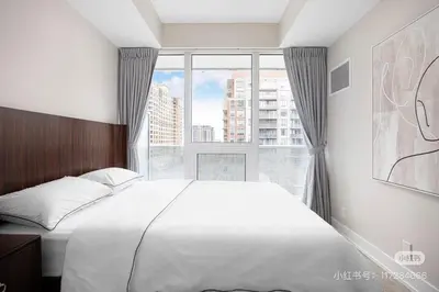a bedroom with a large bed and a large window at KK Hotel in Markham