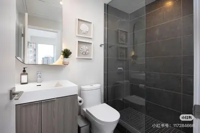 a bathroom with a toilet and a sink and a shower at KK Hotel in Markham