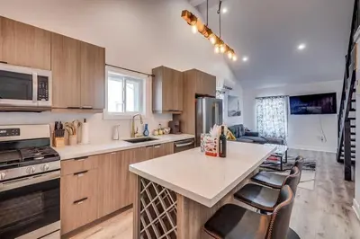 a kitchen with wooden cabinets and a counter top at Niagara Falls 2BR Unit in Niagara Falls
