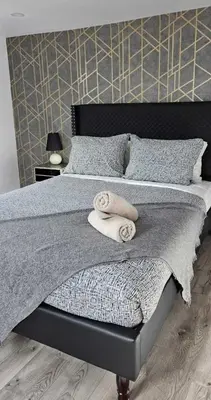 a bedroom with a bed with towels on it at Niagara Falls 2BR Unit in Niagara Falls