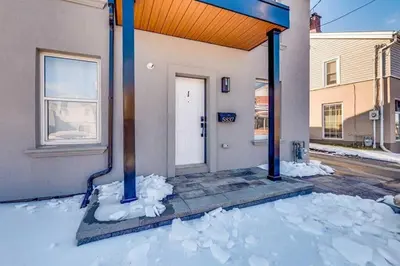 a front door of a house with snow around it at Niagara Falls 2BR Unit in Niagara Falls