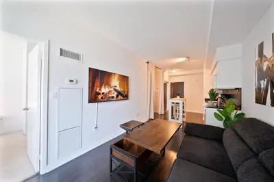 a living room with a couch and a table at Skyline Stays Chic 2BR Steps from Everything in Toronto