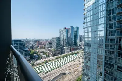 a view of a city from a building at Skyline Stays Chic 2BR Steps from Everything in Toronto