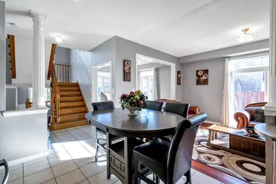 a living room with a table and chairs at Thrilling Homey Escape In Toronto Area in Ajax