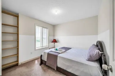 a bedroom with a bed and a window at Exhilarating Castle Vibes In Toronto Area in Ajax