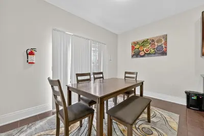 a dining room with a wooden table and chairs at Spacious Modern 5BR Home Sleeps 13 Family home in Milton