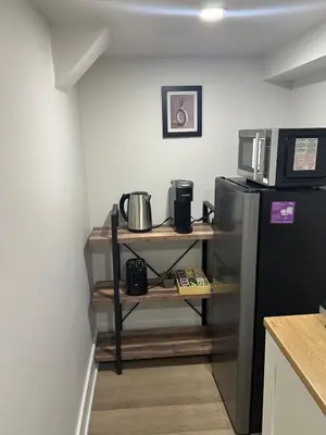 a kitchen with a black refrigerator and a microwave at Cozy Basement Studio with Private Bathroom and Kitchen in Vaughan