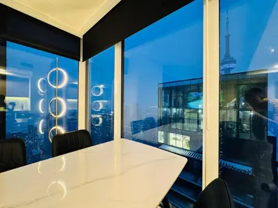 a white table in a room with a large window at Luxury 76 floor 2B2B Downtown Toronto Skyline View in Toronto