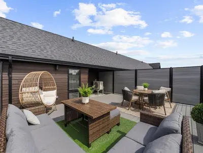 a patio with a table and chairs on a roof at 2BR Penthouse Rooftop, Parking, Close to the Falls in Niagara Falls