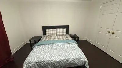 a bedroom with a bed and two night stands at Maple in Mississauga