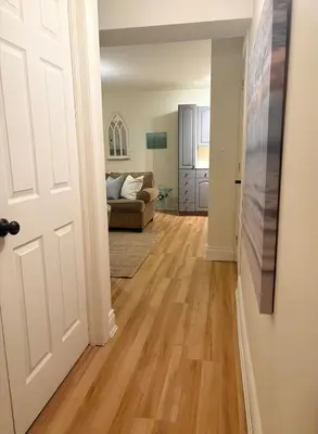 an open door to a living room with a couch at Charming private Guest Suite near Thermea Spa in Whitby
