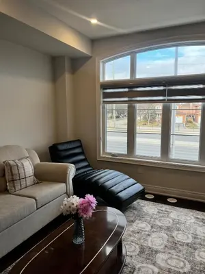 a living room with a couch and a table at Modern Luxury Townhome with 2BR Balcony plus Parking - Happy Oaks in Oakville