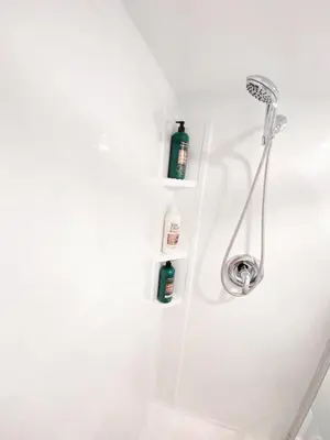 a bathroom with a shower with two bottles on the wall at ClassicPavillion INN in Bowmanville