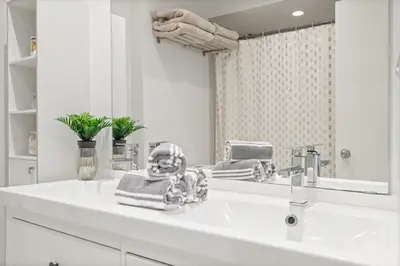 a white bathroom with a sink and a mirror at 4BR Family Home - Dog-Friendly, Huge Yard, 5 Beds in Pickering