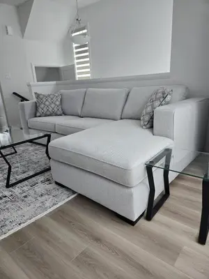 a living room with a couch and a glass table at Modern 3BR FriendlyTown Home in Paris