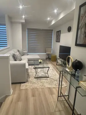 a living room with a couch and a table at Modern 3BR FriendlyTown Home in Paris