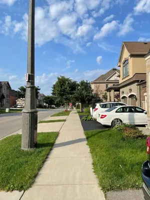 a pole on the side of a street with parked cars at One bedroom and studio Basement Apartment unit sleeps 4 in Oakville