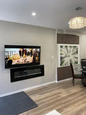 a living room with a flat screen tv on a wall at One bedroom and studio Basement Apartment unit sleeps 4 in Oakville