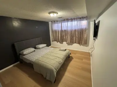 a small bedroom with a bed and a window at Private Room Near Airport D89 in Mississauga