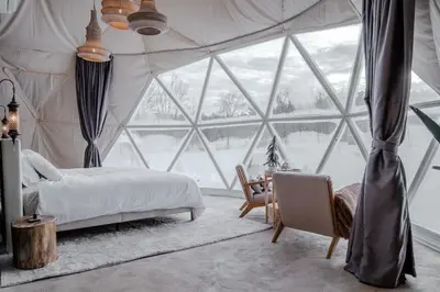 a bedroom with a bed and a large window at 'MoonBeam' Boho-Luxe Glamping Dome at Marmora Retreat in Marmora