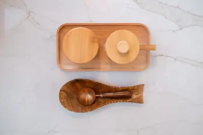 a wooden tray with a wooden spoon on a counter at 'MoonBeam' Boho-Luxe Glamping Dome at Marmora Retreat in Marmora