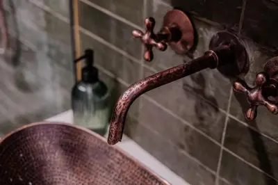 a bathroom sink with a rusty faucet and a bottle of soap at 'MoonBeam' Boho-Luxe Glamping Dome at Marmora Retreat in Marmora