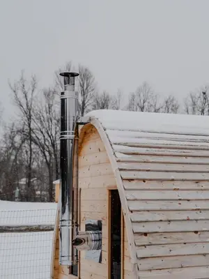 a wooden building with a chimney on top of it at 'Twilight' Boho-Luxe Glamping Dome at Marmora Retreat in Marmora