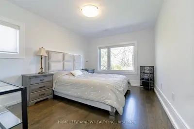 a white bedroom with a bed and a window at Luxury Modern Retreat in Richmond Hill in Richmond Hill