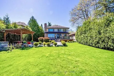 a house with a large yard with green grass at Luxury Modern Retreat in Richmond Hill in Richmond Hill
