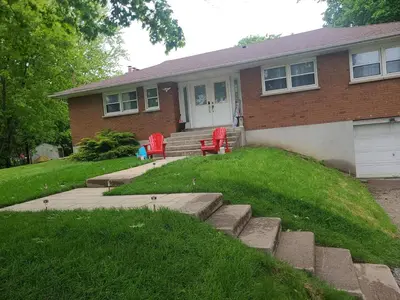 a house with red chairs in front of it at The Taunton House in Ajax