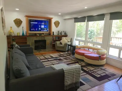 a living room with a couch and a tv at The Taunton House in Ajax