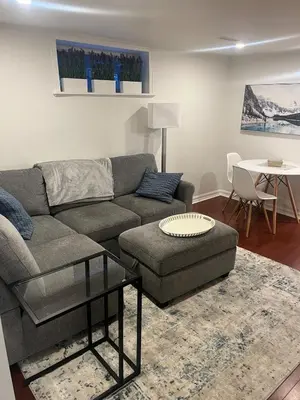 a living room with a couch and a table at 1 Bedroom basement Suite in Junction Bloor West Village in Toronto