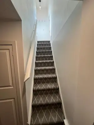 an empty stairway with a set of grey stairs at 1 Bedroom basement Suite in Junction Bloor West Village in Toronto